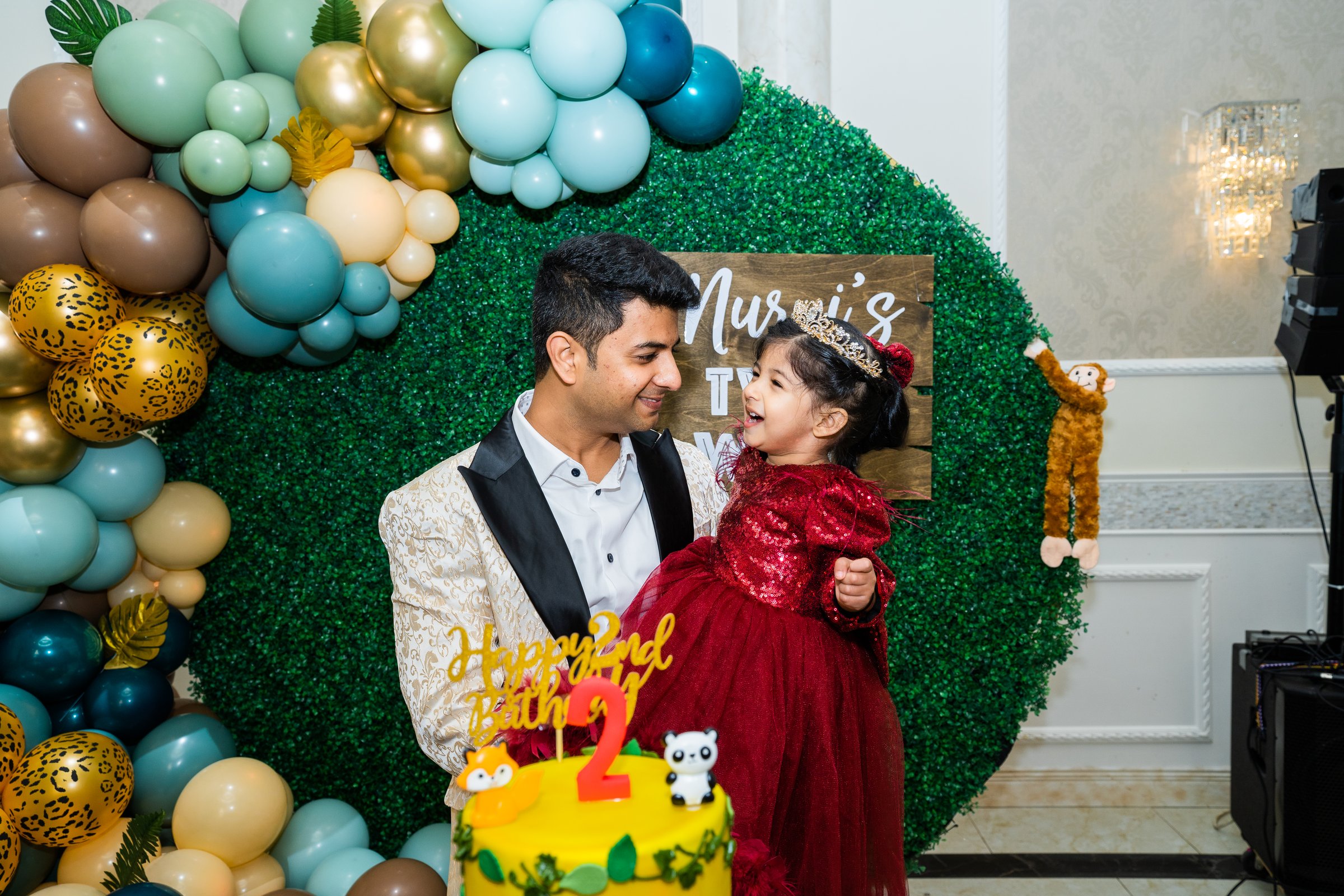 Nurvi's 2nd birthday father daughter laughing at cake