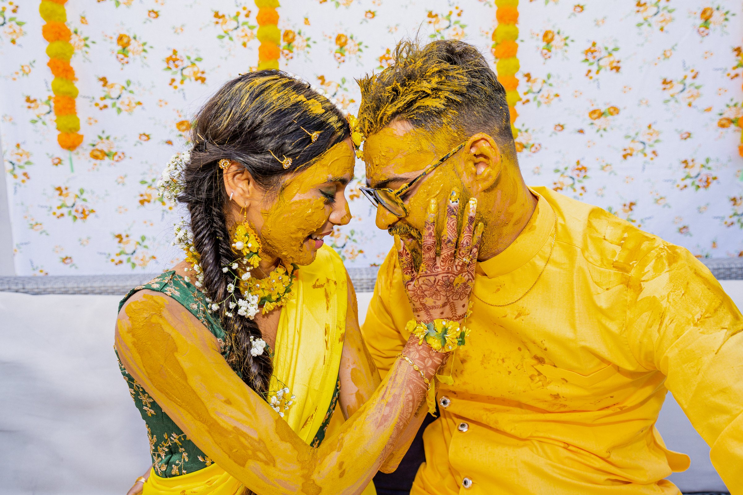 Aanal and vihar wedding haldi foreheads together laughing