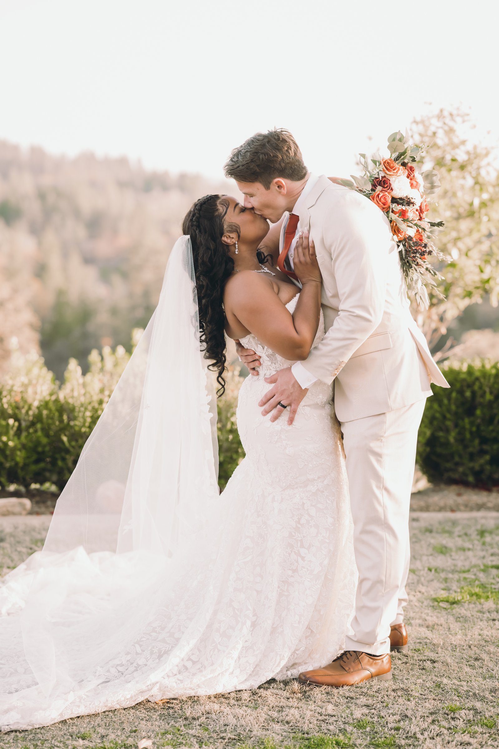 Ariel and devaughn's wedding golden hour dip kiss